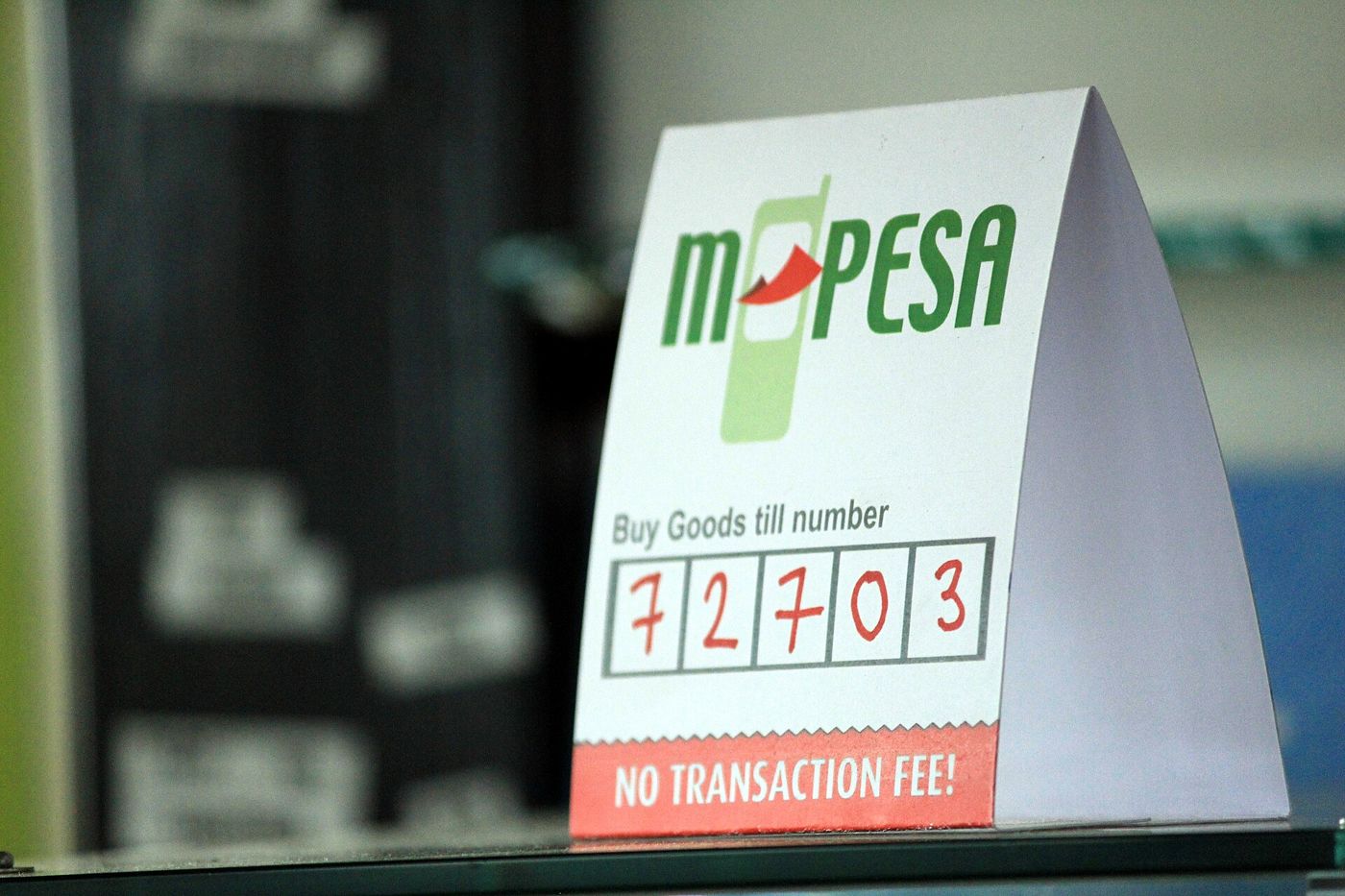 An M-Pesa Buy Goods till number sign on a shop counter